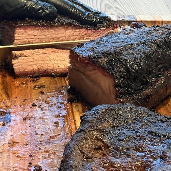 Kasper’s BBQ & Hummus - a piece of meat on a cutting board - Barbeque Near Me Kasper’s BBQ & Hummus - a piece of meat on a cutting board - Barbeque Near Me