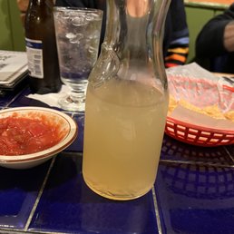 a pitcher of lemonade and a bowl of salsa a pitcher of lemonade and a bowl of salsa