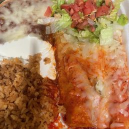 Carnitas enchiladas with red sauce refried beans and rice Carnitas enchiladas with red sauce refried beans and rice