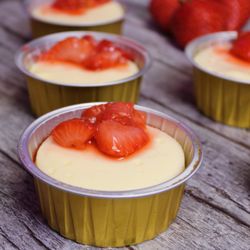 Toni's Tasty Treats - Fluffy cheesecake with a buttery graham cracker crust and strawberry sauce