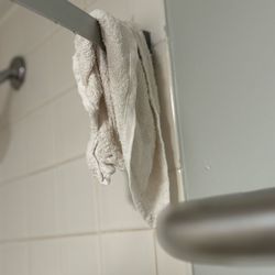 River Edge Inn - Used washcloth left on the shower curtain rod
