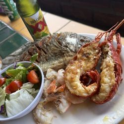 La Casa del Pescador - Combo plate. Grilled Shrimp, two lobster tails and a fried whole fish. Includes rice, beans and those delicious fresh flour tortillas!