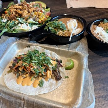 Torchy's Tacos - Tokyo Drift Taco, sides of rice with beans and the salad with chicken corn and avocado. - Tacos Near Me - Orlando, Florida Torchy's Tacos - Tokyo Drift Taco, sides of rice with beans and the salad with chicken corn and avocado. - Tacos Near Me - Orlando, Florida