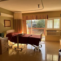 Life Care Center of Federal Way - "A cozy single bed, overlooking a balcony and greenery through large windows.The room has warm, inviting colors and a comfortable setup,