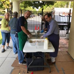 Montessori Children's House of St James - School parents and Knights preparing our Fish Fry dinners!