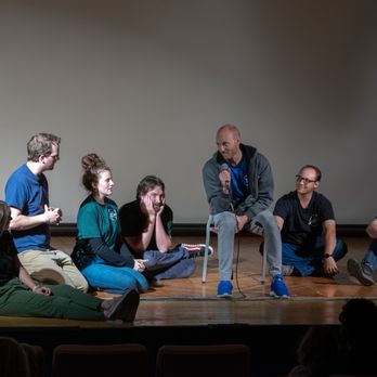 The Antics Comedy Improv - a group of people sitting on a stage - Comedy Clubs Near Me - Logan, Utah