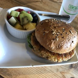 Zucchini white bean burger with fresh fruit and a cup of water. Zucchini white bean burger with fresh fruit and a cup of water.