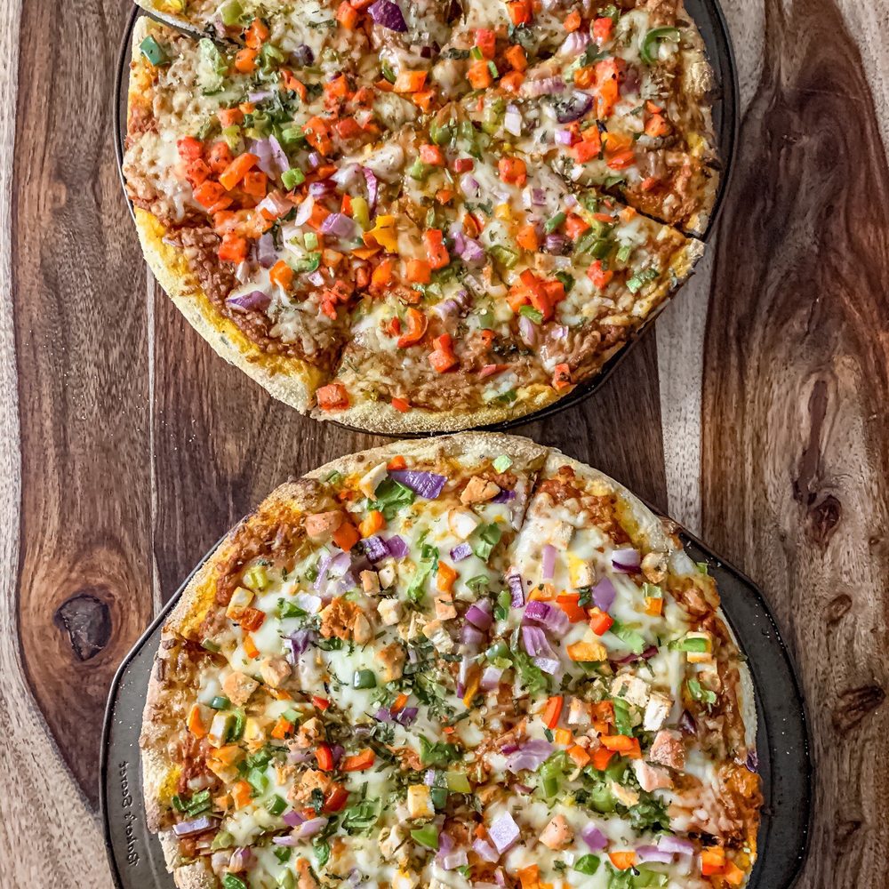 Chili Craft Pizza - two pizzas on a wooden table - Indian Near Me - Nepean, Ontario