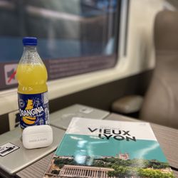 Dream Vacations with Angela Pope - Train from Lyon to Paris Vieux Lyon Magazine Orangina drink