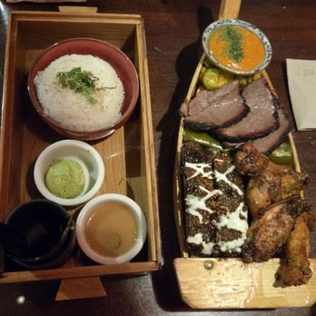 Kemuri Tatsu-ya - BBQ Boat (Smoked wings, Brisket, Ribs) on right +Bento on left - Izakaya Near Me - Austin, Texas Kemuri Tatsu-ya - BBQ Boat (Smoked wings, Brisket, Ribs) on right +Bento on left - Izakaya Near Me - Austin, Texas