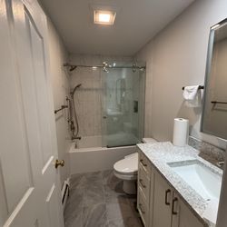 Ironwood Construction & Design - Full bathroom renovation. Tile floor and shower installed. Vanity and medicine cabinet installed.