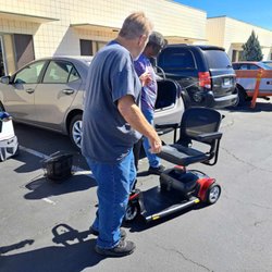 Gino showing us how to break down the scooter to fit into the trunk.