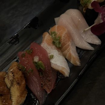 Umami - Left to Right: Freshwater eel Garlic Tuna* (2 pcs) Salmon Belly* (2 pcs) Yellowtail* (2 pcs) Aomori Scallop* (2 pcs) - Japanese Near Me - Las Vegas, Nevada Umami - Left to Right: Freshwater eel Garlic Tuna* (2 pcs) Salmon Belly* (2 pcs) Yellowtail* (2 pcs) Aomori Scallop* (2 pcs) - Japanese Near Me - Las Vegas, Nevada