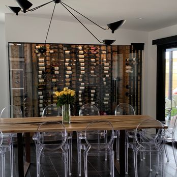 Liquid Assets Cellars - a dining table with clear chairs - Wineries Near Me - North Hollywood, California