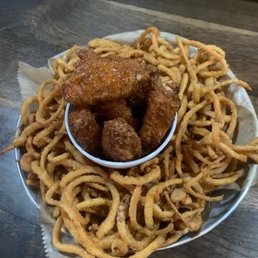 Birds nest (appetizer). Chicken wings with onion straws/rings