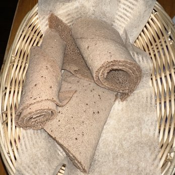 Tsion Cafe - a basket of rolled towels on a table - Ethiopian Near Me - New York, New York
