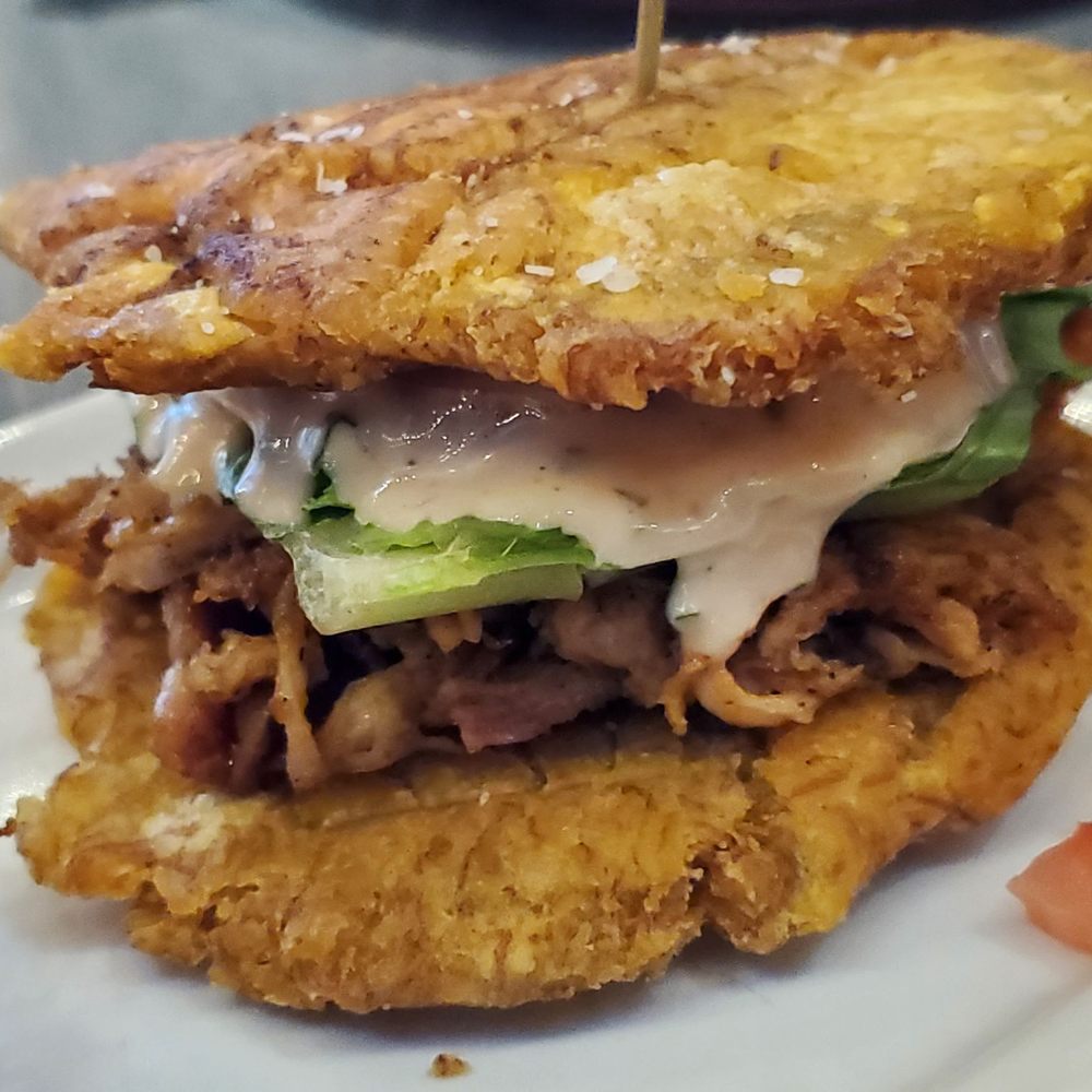 Noche Restaurant & Bar - Hamburguesa Costa - Costa Rican dish, similar to a Puerto Rican Jibarito, where fried plantain (tostones) take the place of a bun. - Tapas/Small Plates Near Me - Greendale, Wisconsin Noche Restaurant & Bar - Hamburguesa Costa - Costa Rican dish, similar to a Puerto Rican Jibarito, where fried plantain (tostones) take the place of a bun. - Tapas/Small Plates Near Me - Greendale, Wisconsin