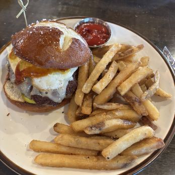 Finley's Round Rock - BYOB - Pretzel bun, mustard, pickles, bbq sauce, pepper jack, fried egg and fries - Delicious !!! - Bars Near Me - Round Rock, Texas