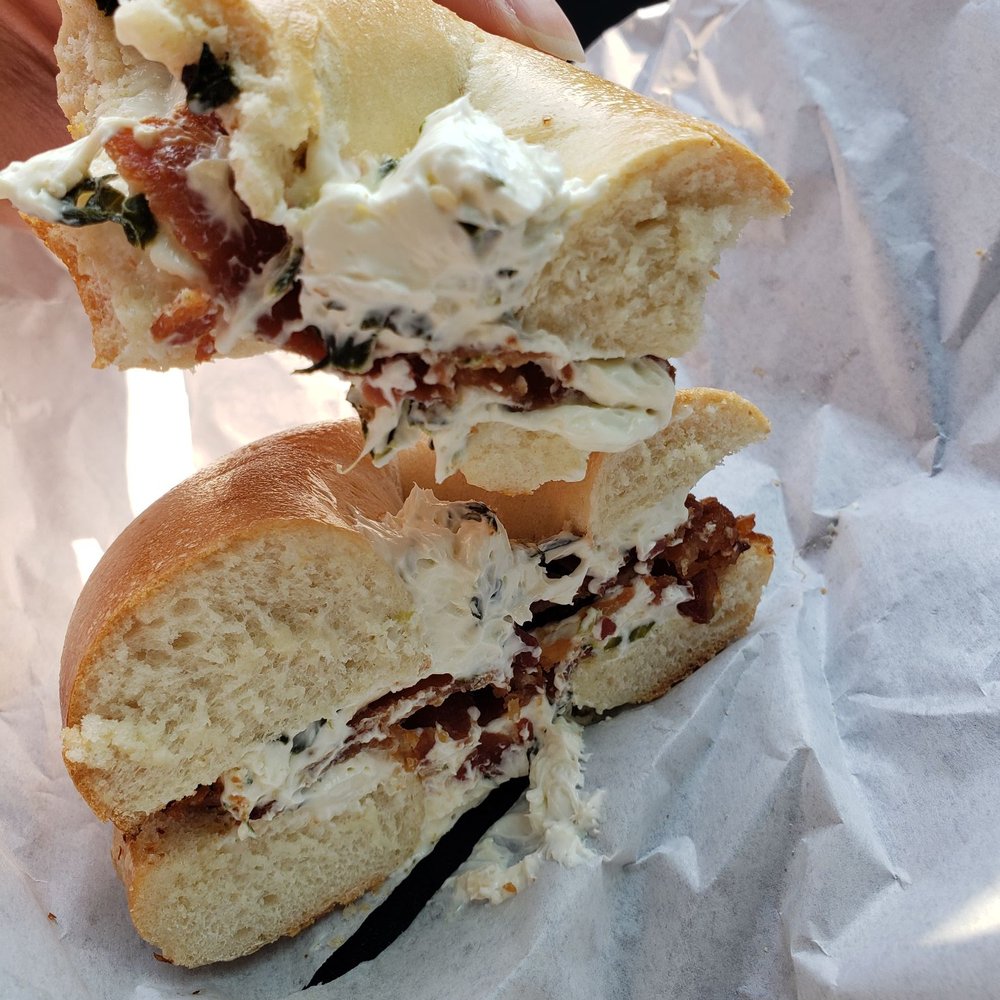 Delicious Donuts and Bagels - Spinach and garlic cream cheese with added bacon on a toasted plain bagel - Donuts Near Me - Newark, California Delicious Donuts and Bagels - Spinach and garlic cream cheese with added bacon on a toasted plain bagel - Donuts Near Me - Newark, California