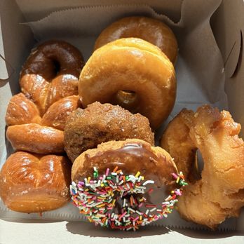 Friendly Donut House - Bow tie on the left, 2 glazed at the top, Blueberry Cake in the middle, buttermilk on the right, chocolate cake on the bottom - Donuts Near Me - Henderson, Nevada