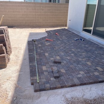 Domestic Landscape - Pavers being installed out back patio door - Tree Services Near Me