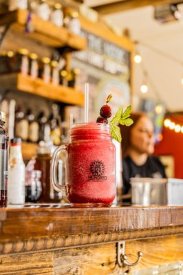 Photo of 3 Hundred Days Distilling - Monument, CO, US. a red drink with a straw and garnish