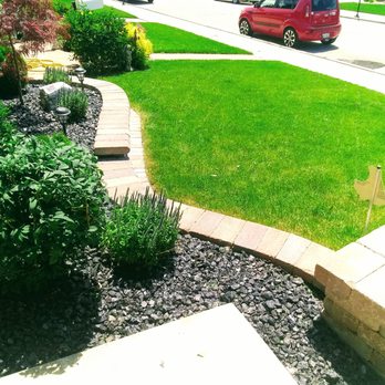Robert's Lawn Care - a red car driving down the street - Lawn Services Near Me Robert's Lawn Care - a red car driving down the street - Lawn Services Near Me