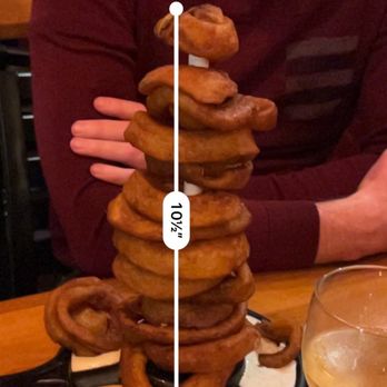 Birds - a man sitting at a table with a stack of donuts - New American Near Me - Los Angeles, California Birds - a man sitting at a table with a stack of donuts - New American Near Me - Los Angeles, California