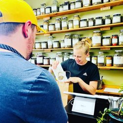 Dragon Roots Tea Shoppe & Herbal Supply - Owner at the register.