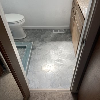Stranahan Tile - a bathroom with a toilet and sink - Tiling Near Me Stranahan Tile - a bathroom with a toilet and sink - Tiling Near Me