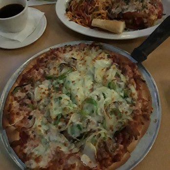 Moretti's Ristorante and Pizzeria - A small thin crust, sausage, mushroom, onion, green pepper, and black olive pizza next to a plate of chicken parmesan. - Italian Near Me - Chicago, Illinois