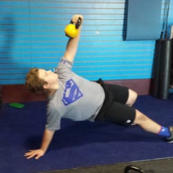 Elevate Strength & Conditioning - An Orono Spartans football player performing a Turkish Get-Up as part of a sports performance program.