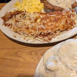 Chicken fried steak with country gravy, shredded hash browns and scrambled eggs.