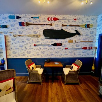 Mookie’s at Mugford - a living room with a wall of paddles on the wall - Coffee & Tea Near Me - Marblehead, Massachusetts Mookie’s at Mugford - a living room with a wall of paddles on the wall - Coffee & Tea Near Me - Marblehead, Massachusetts