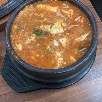 Cho Dang Village - Kimchi with tofu and beef. Egg added while stlll boiling at table. Why it looks messy! Delicious! Spicy level 5. - Korean Near Me - Plano, Texas