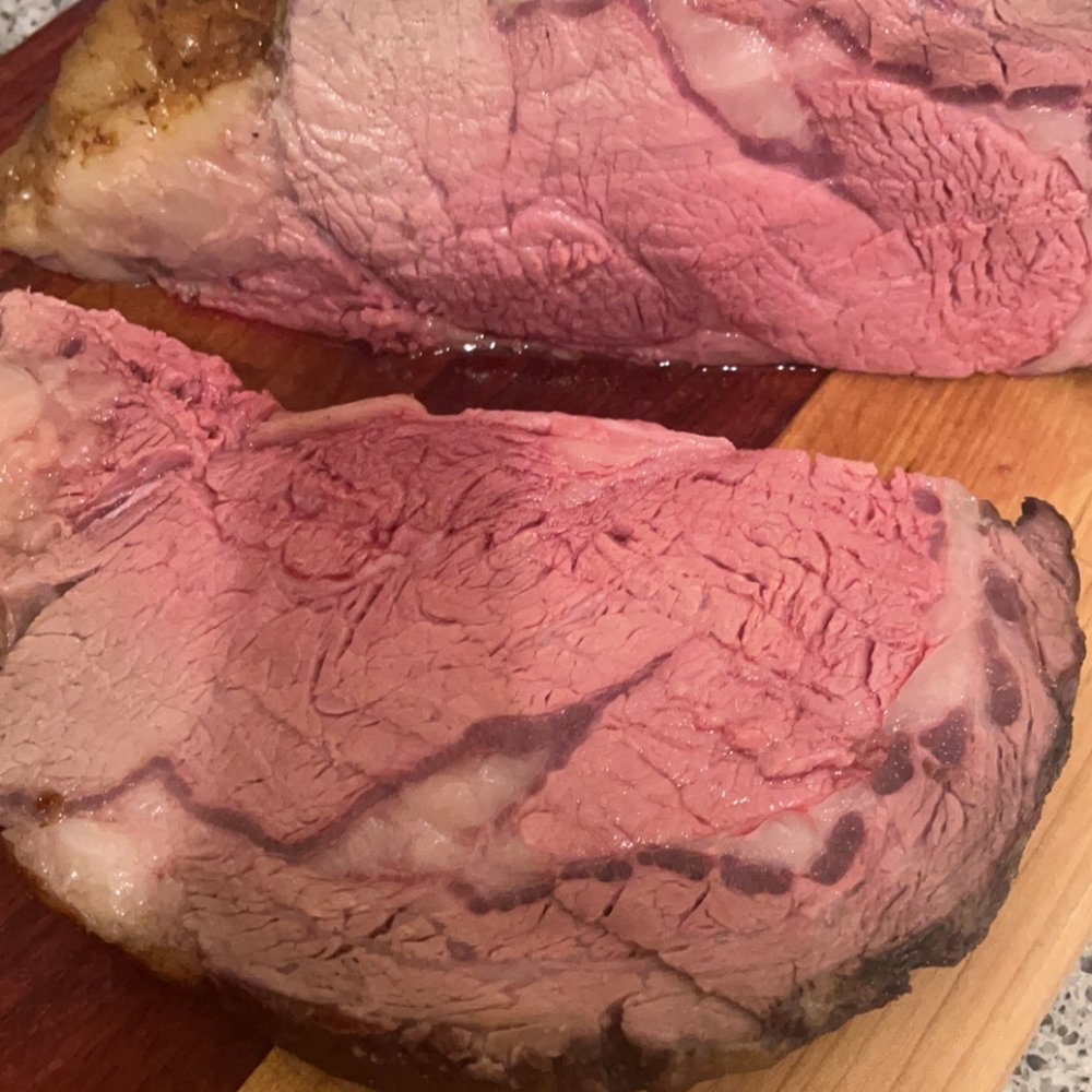 two slices of beef on a cutting board two slices of beef on a cutting board