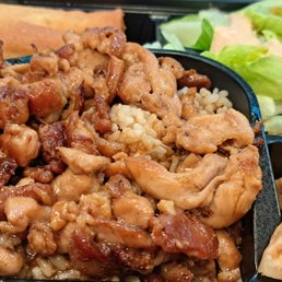 a meal of chicken, rice, and lettuce