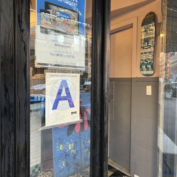 Bite - a sign in the window of a fast food restaurant - Sandwiches Near Me - New York, New York