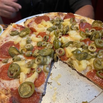 Bluetick Tavern - Vegan cheese pizza, with pepperoni, pineapple, jalapeños, and green olives. - Pizza Near Me - Maryville, Tennessee Bluetick Tavern - Vegan cheese pizza, with pepperoni, pineapple, jalapeños, and green olives. - Pizza Near Me - Maryville, Tennessee