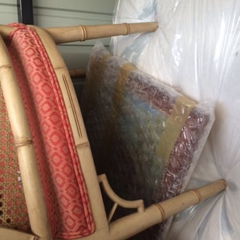AK Movers - Wood chair lying sideways, with artwork. - Movers Near Me - Rockville, Maryland