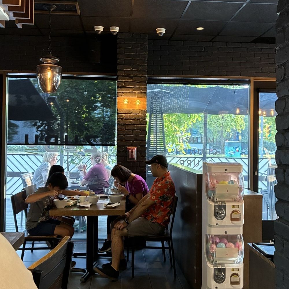 ZUBU - Interior, regular seating, Gachapon capsule toys come with the kids meals. Shows a little bit of their patio seating space. - Ramen Near Me - Burnaby, British Columbia