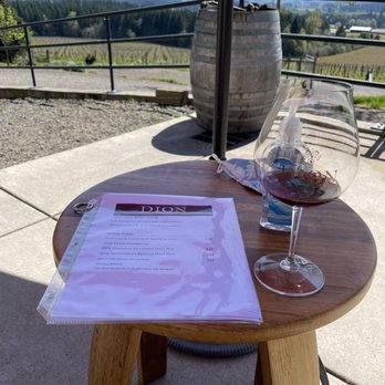 Dion Vineyard - a glass of wine on a table - Wine Tasting Room Near Me - Cornelius, Oregon