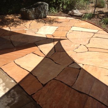 Top Notch Tile - a stone patio with a circular design - General Contractors Near Me Top Notch Tile - a stone patio with a circular design - General Contractors Near Me