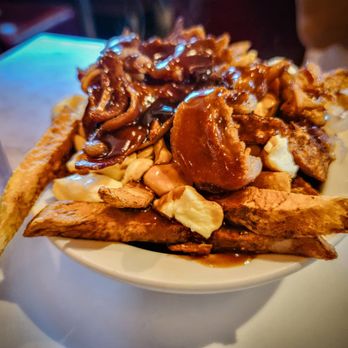 Greenspot Restaurant - a plate of french fries covered in bbq sauce - Canadian (New) Near Me - Montreal, Quebec