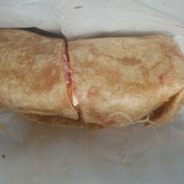 a burrito wrapped in wax paper a burrito wrapped in wax paper