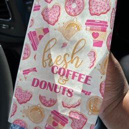 a bag of fresh coffee and donuts a bag of fresh coffee and donuts