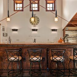 The upstairs bar is located next to the TV area and pool table.