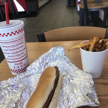 Five Guys - a hot dog and french fries on a table - Burgers Near Me - East Windsor, New Jersey Five Guys - a hot dog and french fries on a table - Burgers Near Me - East Windsor, New Jersey