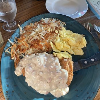 The Mill at The Kasteel - Chicken fried steak with gravy; along with hash browns and scramble eggs. - American Near Me - Oak Harbor, Washington