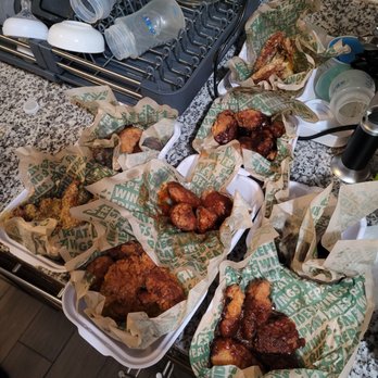 Wingstop - a variety of wings in baskets on a counter - Chicken Wings Near Me - Queens, New York
